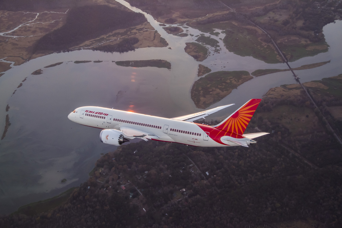 An Air India Boeing 787 in flight over river delta