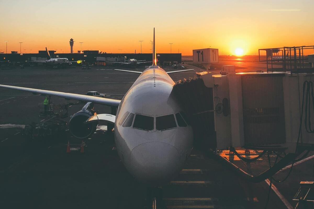 Commercial aircraft parked at the terminal at sunrise